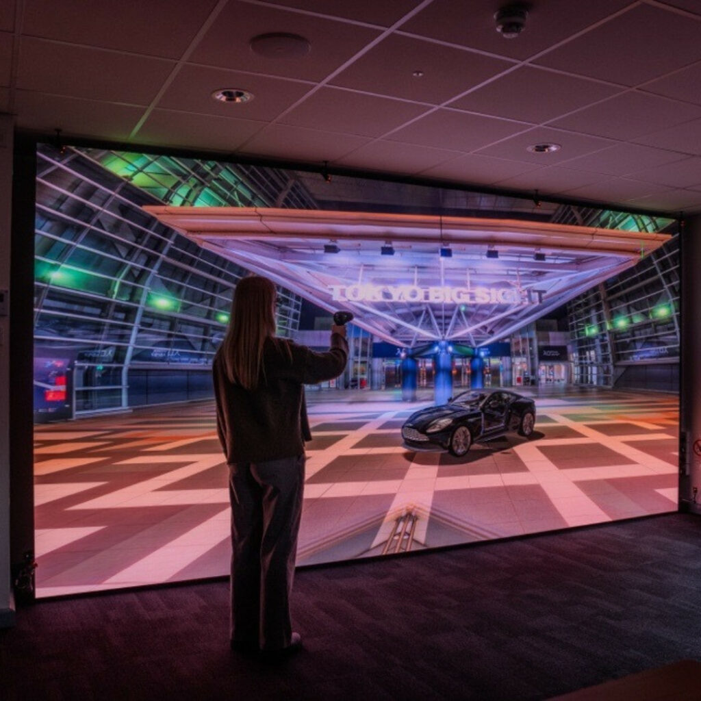 A Regent College London Engineering student interacts with the TEDLab VR wall.
