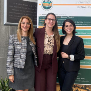 RCL academics Fatemeh Azizi, Athina Ntasioti and Maryam Rouintan stand together smiling at the TIRIAE Conference 2025.