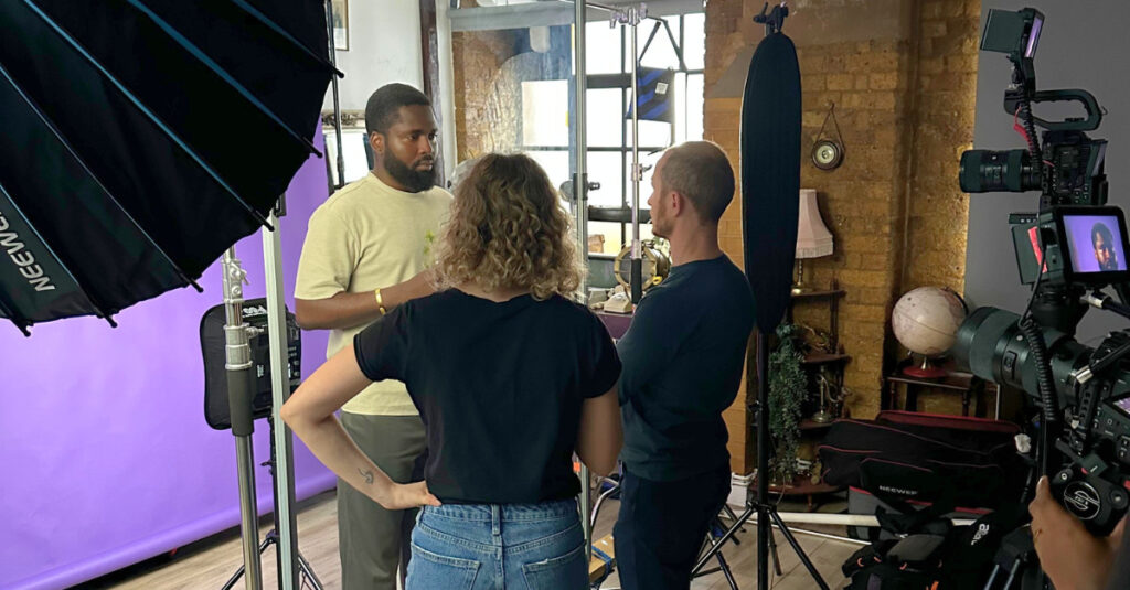 A behind-the-scenes photo from the Restart Stronger video shoot featuring Adeyemi, a Regent College London student.
