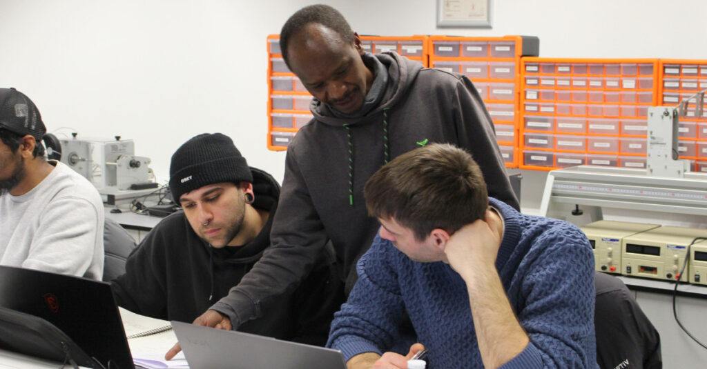 An RCL academic assists Engineering and Computing students in the classroom.