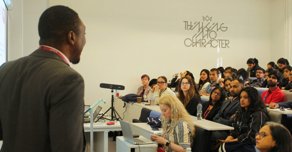 An RCL lecturer delivering a presentation in our Fitzrovia Campus auditorium.