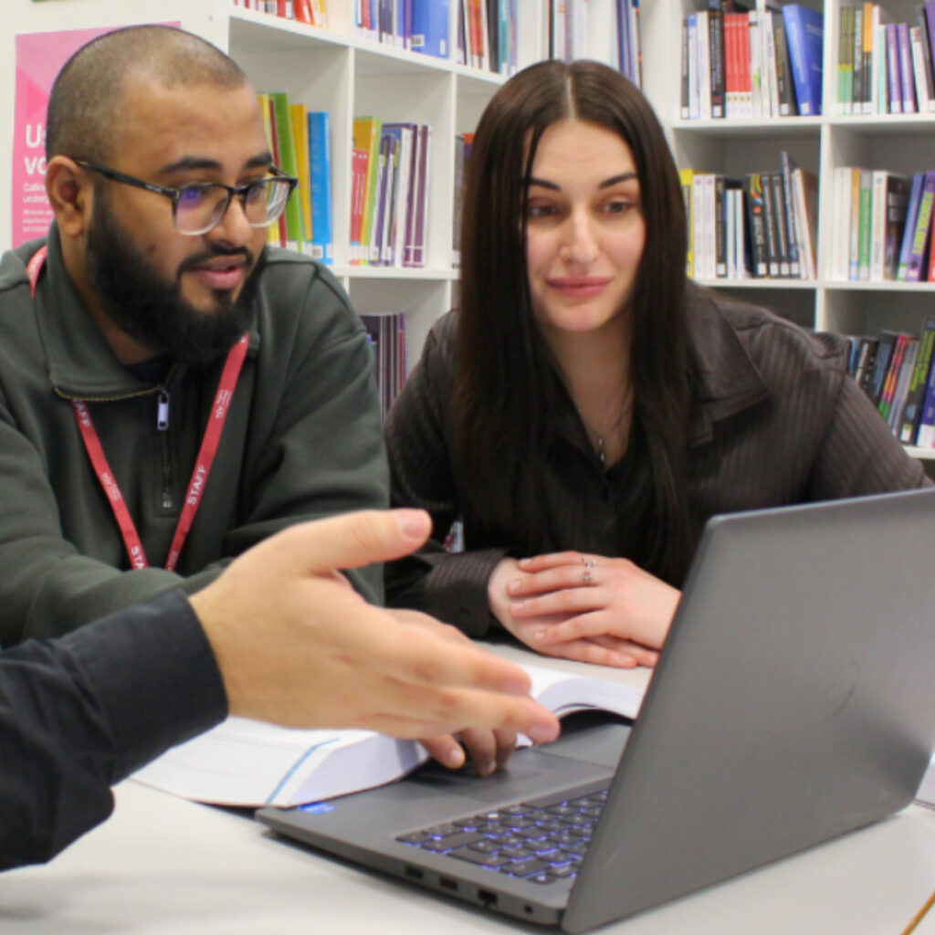 An RCL staff members guides students to make use the Virtual Learning Environment (VLE).