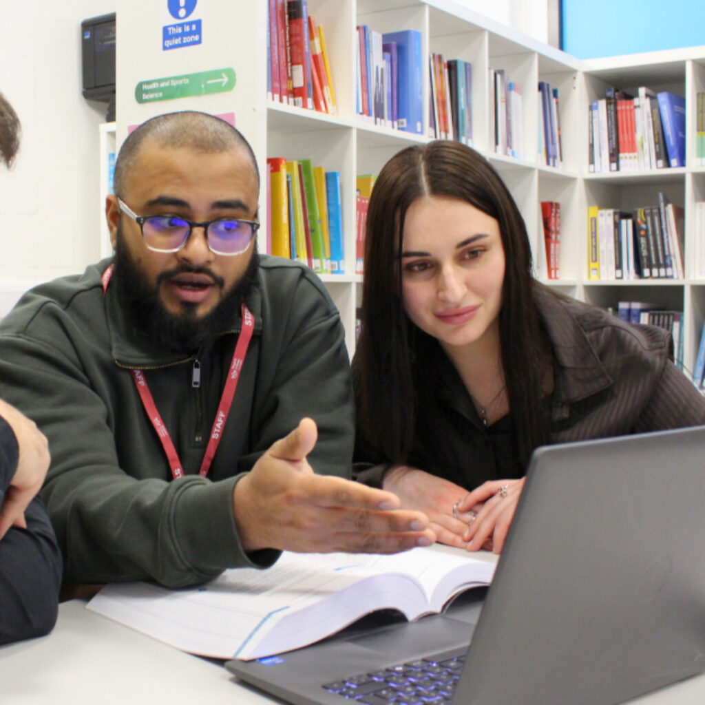 An RCL staff member speaks to RCL students in the library.