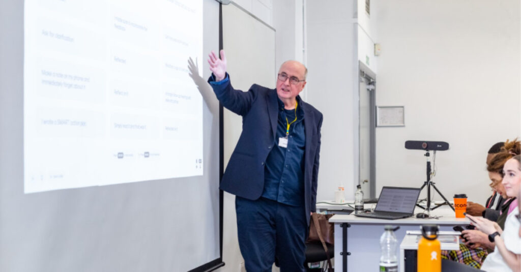 Professor Patrick McGhee, Assistant Vice Chancellor at the University of Greater Manchester, delivering his keynote, “The Psychology of Feedback”.