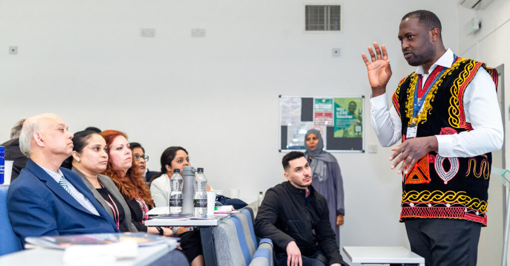 An RCL academic delivers a presentation in a lecture hall.