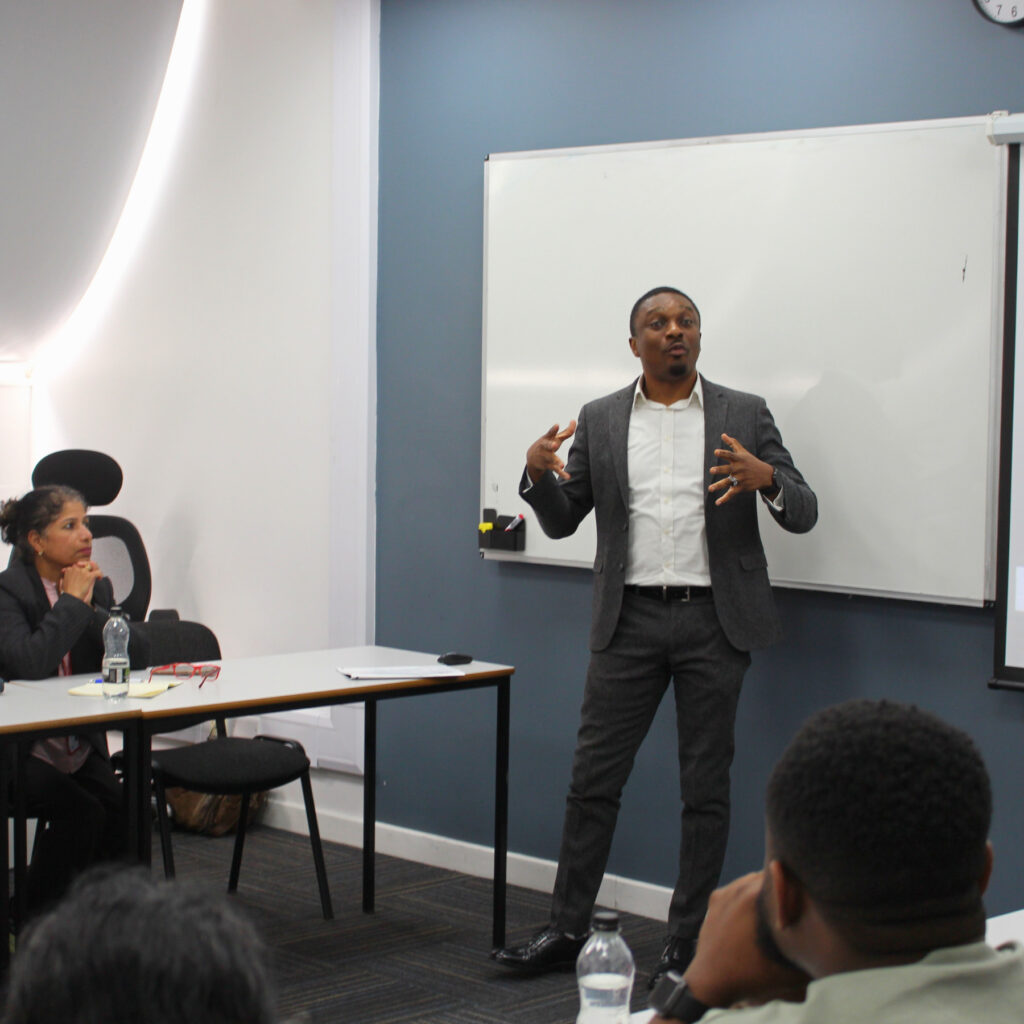 An RCL academic delivers a presentation in a classroom.